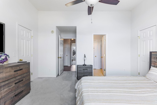 carpeted bedroom with a high ceiling and ceiling fan