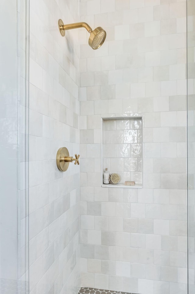 bathroom with tiled shower