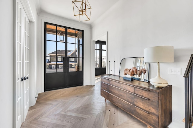 foyer with french doors and light parquet flooring