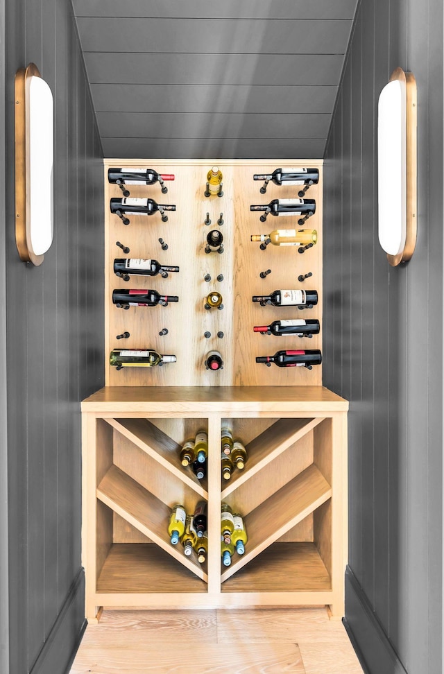 wine area with wooden walls and vaulted ceiling