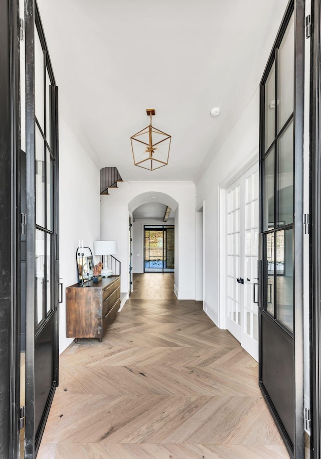 hall featuring light parquet floors and french doors