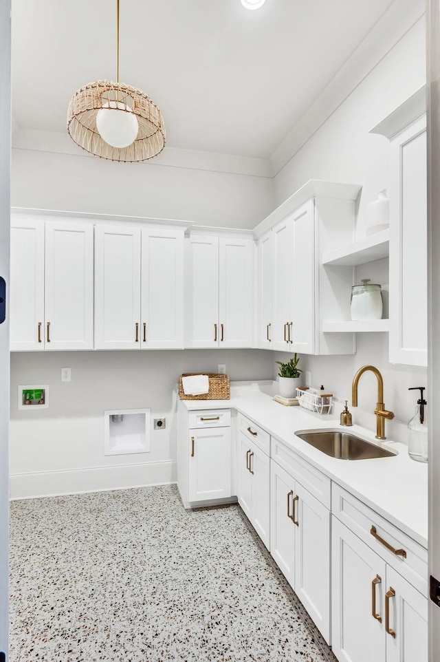 kitchen with crown molding, sink, pendant lighting, and white cabinets