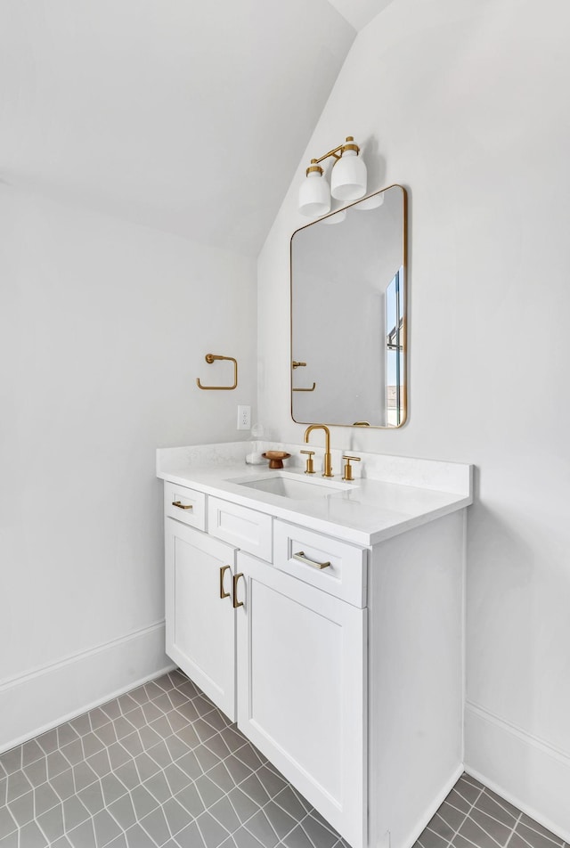 bathroom with vanity, tile patterned floors, and lofted ceiling