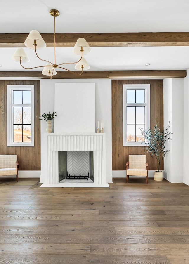 unfurnished living room with hardwood / wood-style flooring and a healthy amount of sunlight