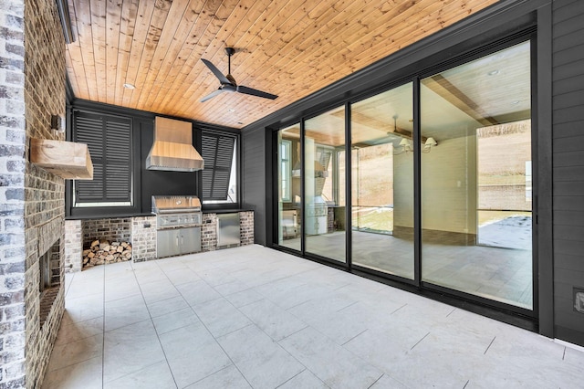 view of patio featuring an outdoor kitchen, a grill, and ceiling fan