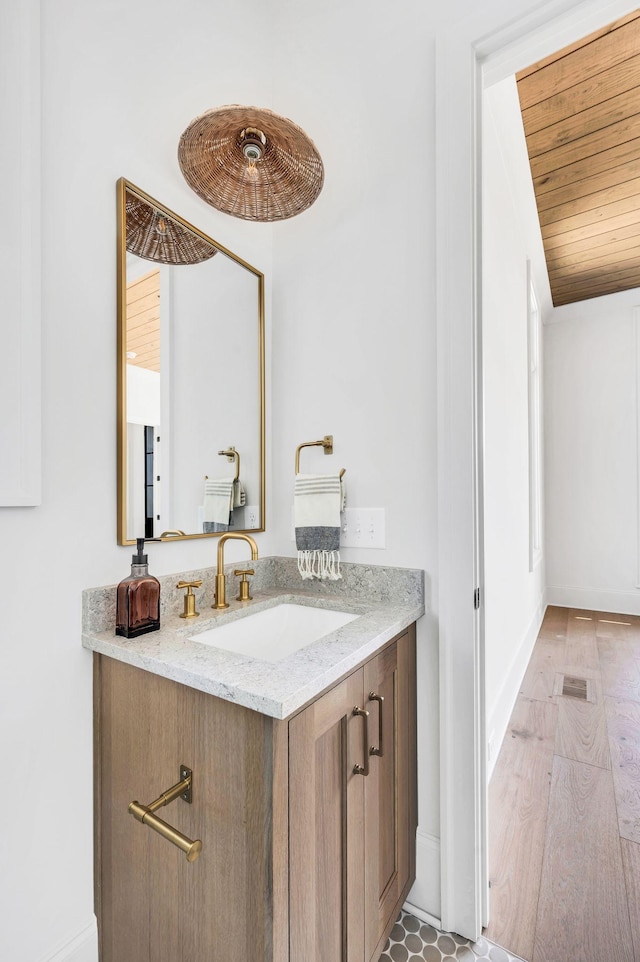 bathroom featuring vanity and wood ceiling