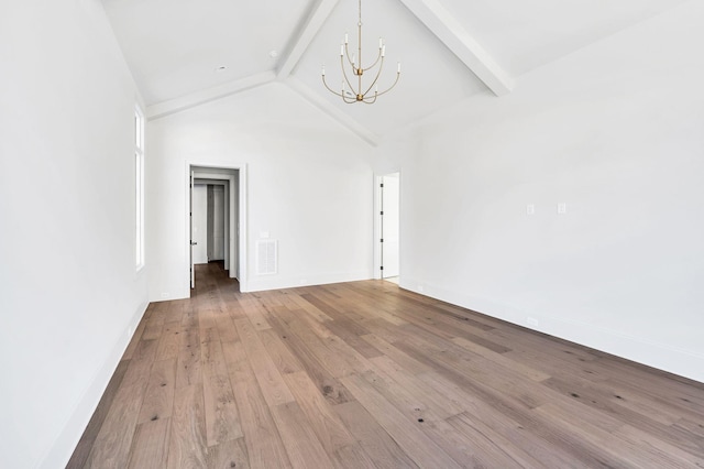 unfurnished room featuring a notable chandelier, beam ceiling, light hardwood / wood-style floors, and high vaulted ceiling