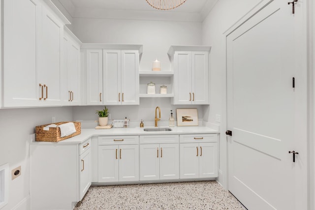 kitchen featuring sink and white cabinets