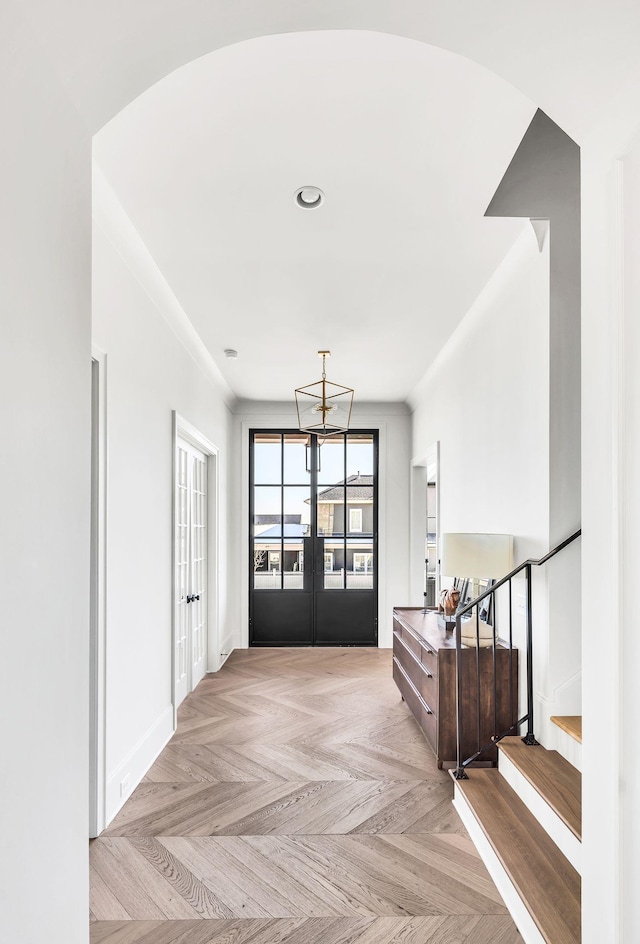 foyer with french doors and light parquet flooring