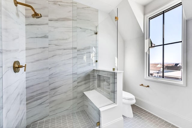 bathroom featuring a tile shower, a wealth of natural light, tile patterned floors, and toilet