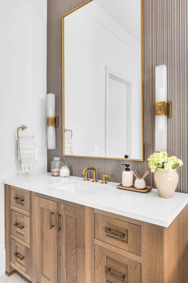 bathroom with crown molding and vanity