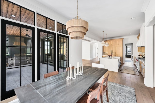 dining space featuring ornamental molding and dark hardwood / wood-style flooring