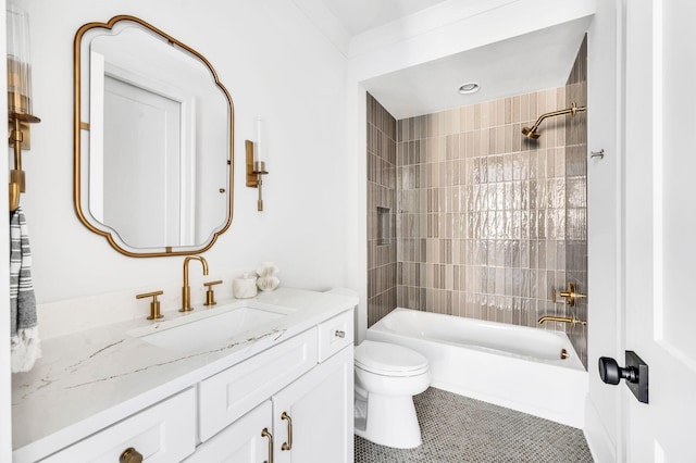 full bathroom with tiled shower / bath, vanity, tile patterned floors, and toilet