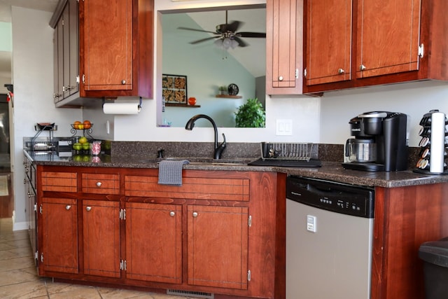 kitchen featuring lofted ceiling, sink, dark stone countertops, dishwasher, and ceiling fan