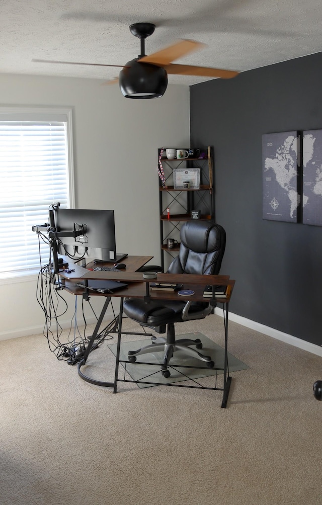 carpeted office with ceiling fan and a textured ceiling