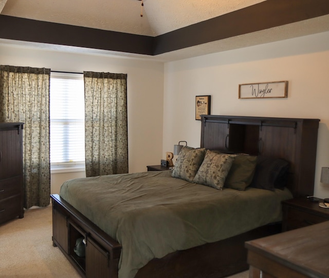 bedroom with vaulted ceiling and light carpet