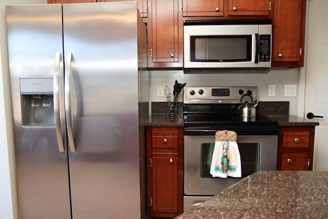 kitchen featuring dark stone counters and appliances with stainless steel finishes