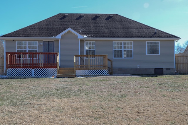 rear view of house featuring a wooden deck and a lawn