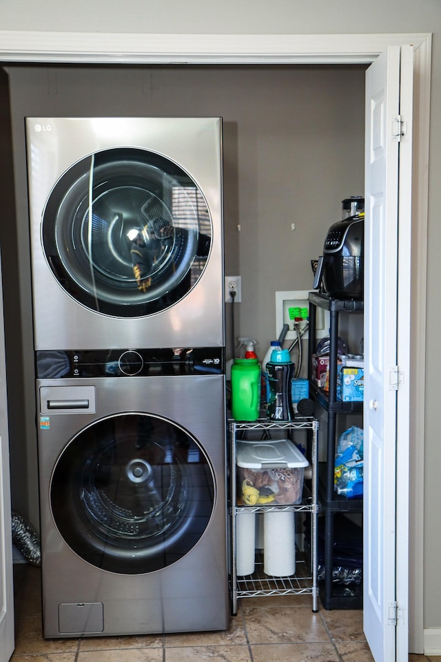 clothes washing area with stacked washer / dryer