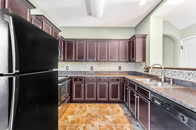 kitchen featuring light tile patterned floors, sink, decorative backsplash, and black appliances