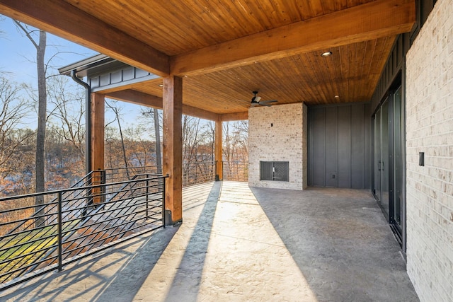 view of patio / terrace featuring ceiling fan and an outdoor stone fireplace