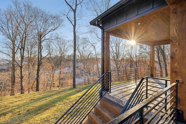 wooden terrace featuring a lawn