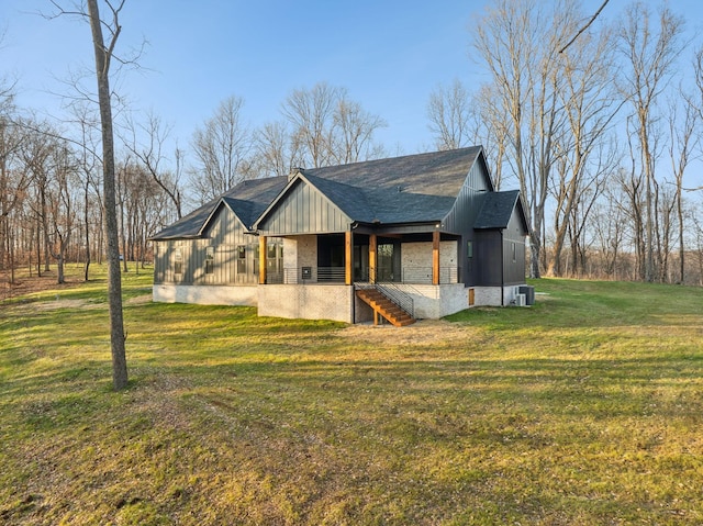 view of side of home featuring a yard and central air condition unit