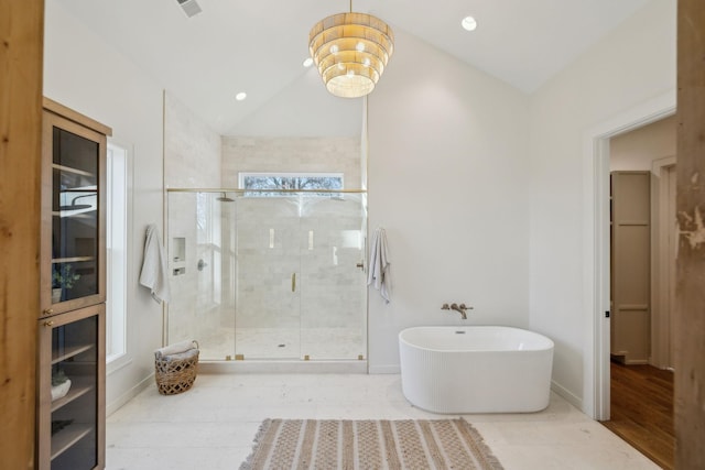 bathroom with tile patterned flooring, a notable chandelier, vaulted ceiling, and separate shower and tub