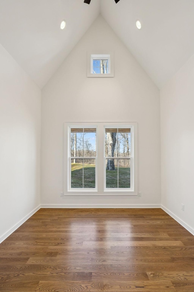 bonus room featuring dark wood-type flooring and high vaulted ceiling