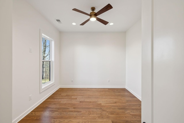 spare room featuring hardwood / wood-style flooring, plenty of natural light, and ceiling fan