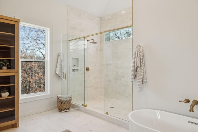 bathroom featuring shower with separate bathtub