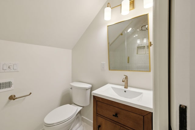 bathroom with vanity, vaulted ceiling, a shower, and toilet