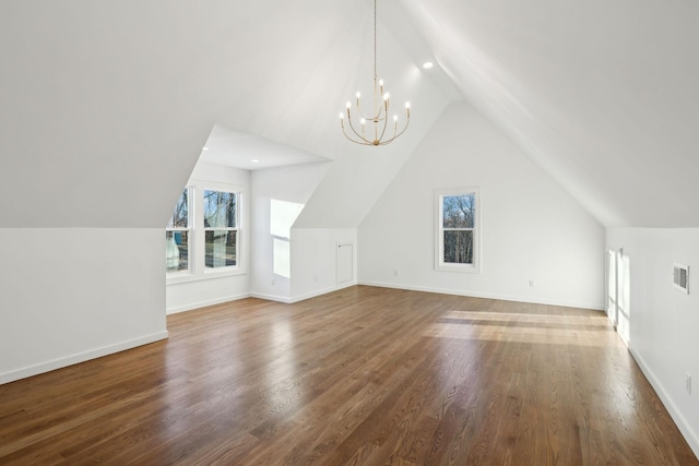 additional living space with lofted ceiling, wood-type flooring, and a chandelier