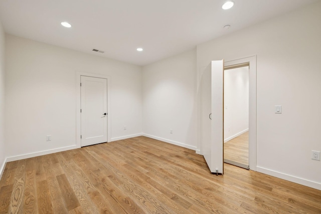 spare room with light wood-type flooring