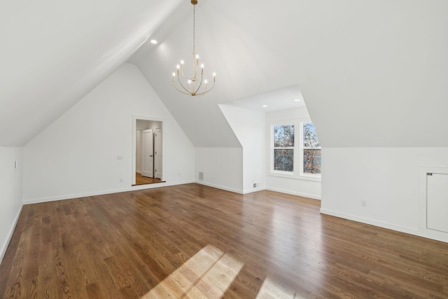 bonus room with hardwood / wood-style flooring, vaulted ceiling, and a notable chandelier