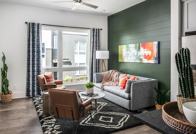 living room featuring dark wood-type flooring, ceiling fan, and a healthy amount of sunlight