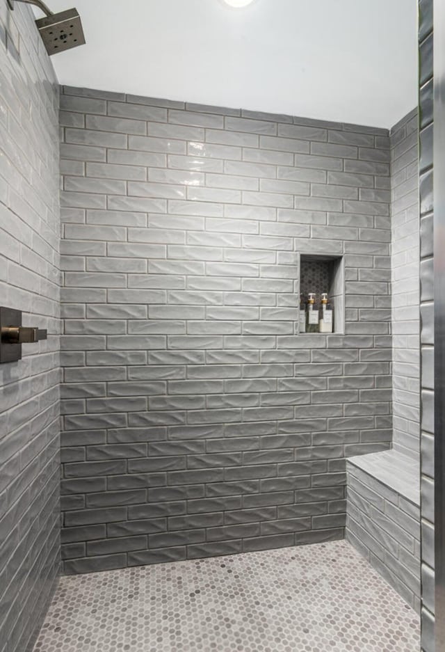 bathroom with a tile shower