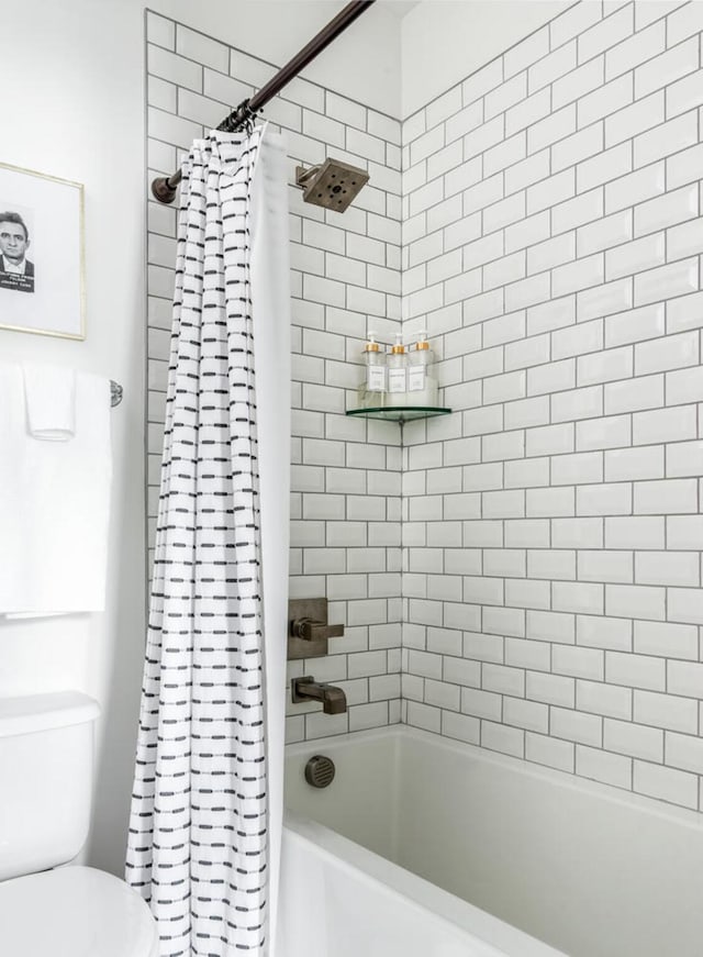 bathroom featuring shower / bathtub combination with curtain and toilet