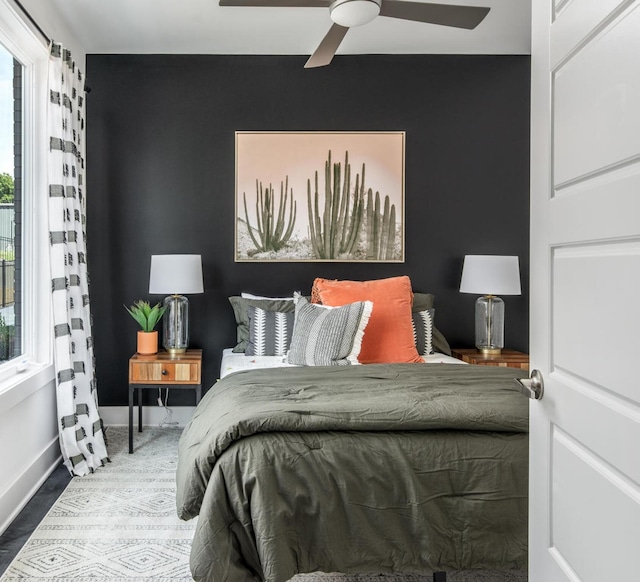 bedroom featuring multiple windows and ceiling fan