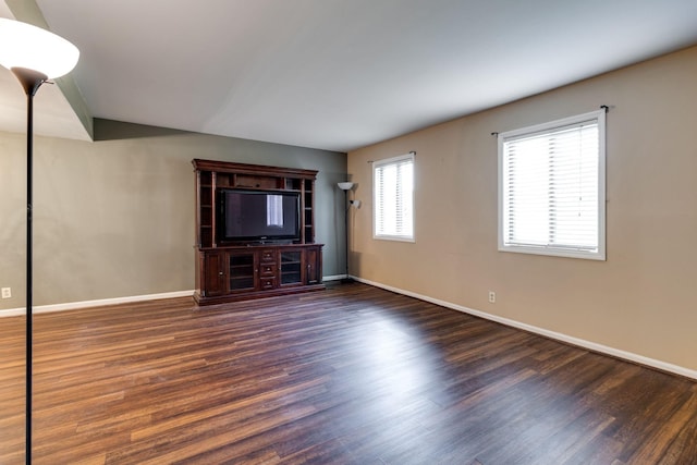 unfurnished living room featuring dark wood-type flooring