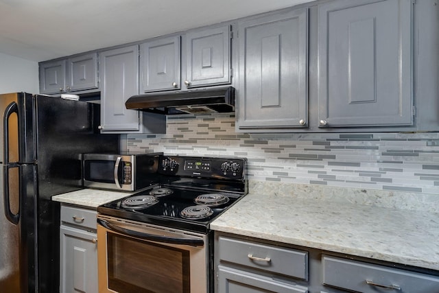 kitchen featuring stainless steel appliances, gray cabinetry, and decorative backsplash