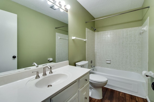 full bathroom featuring hardwood / wood-style flooring,  shower combination, vanity, a textured ceiling, and toilet