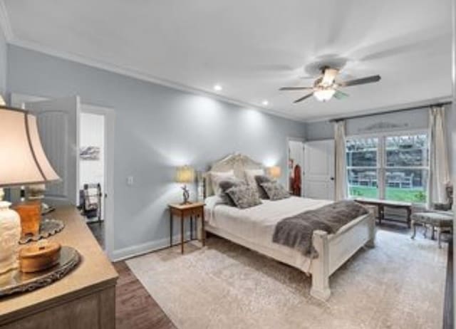 bedroom with ceiling fan, ornamental molding, and light wood-type flooring