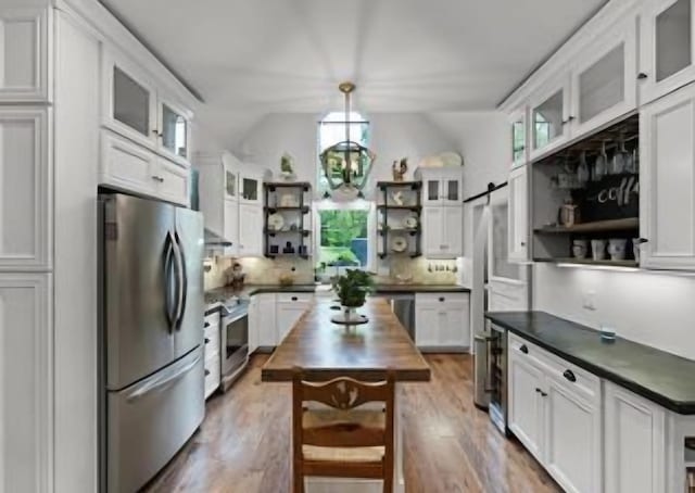 kitchen with white cabinetry, stainless steel appliances, and a kitchen island