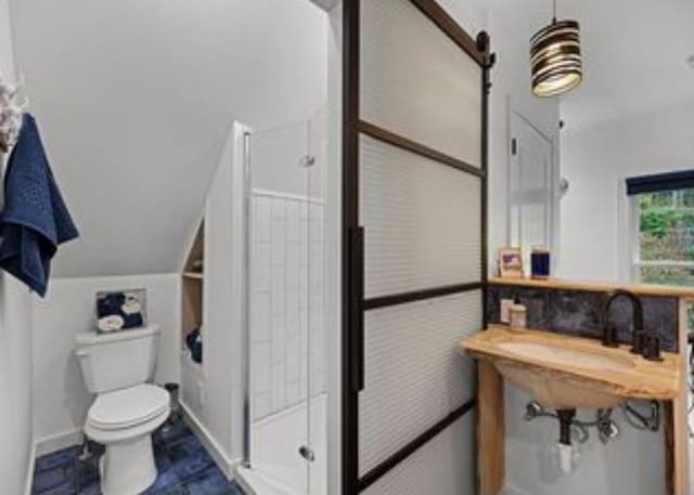 bathroom featuring a shower and toilet