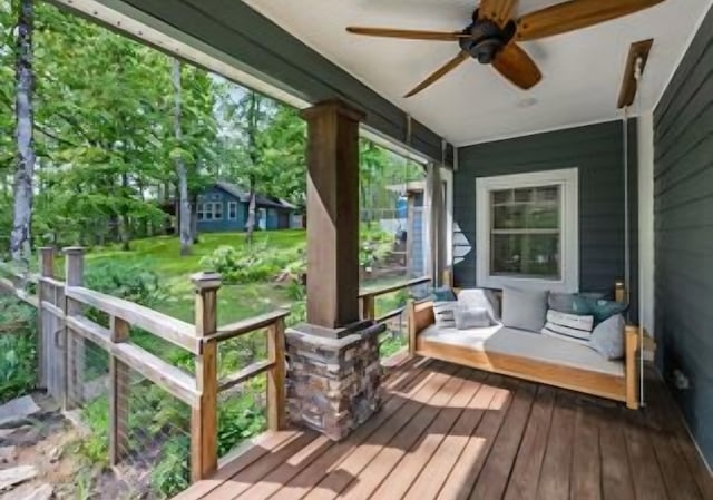 wooden deck featuring a porch and ceiling fan