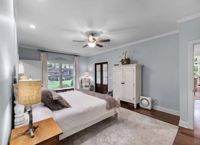 bedroom with crown molding, dark hardwood / wood-style flooring, and ceiling fan