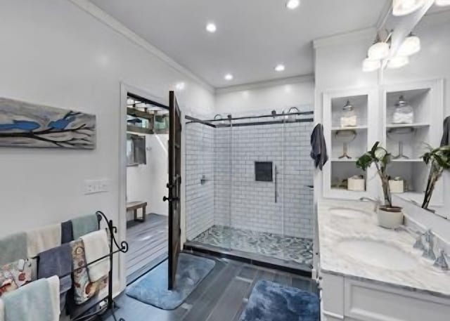 bathroom featuring crown molding, vanity, a shower with shower door, and wood-type flooring