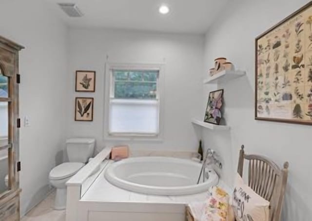 bathroom with a tub and toilet