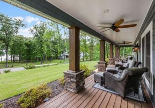 wooden terrace with a yard and ceiling fan